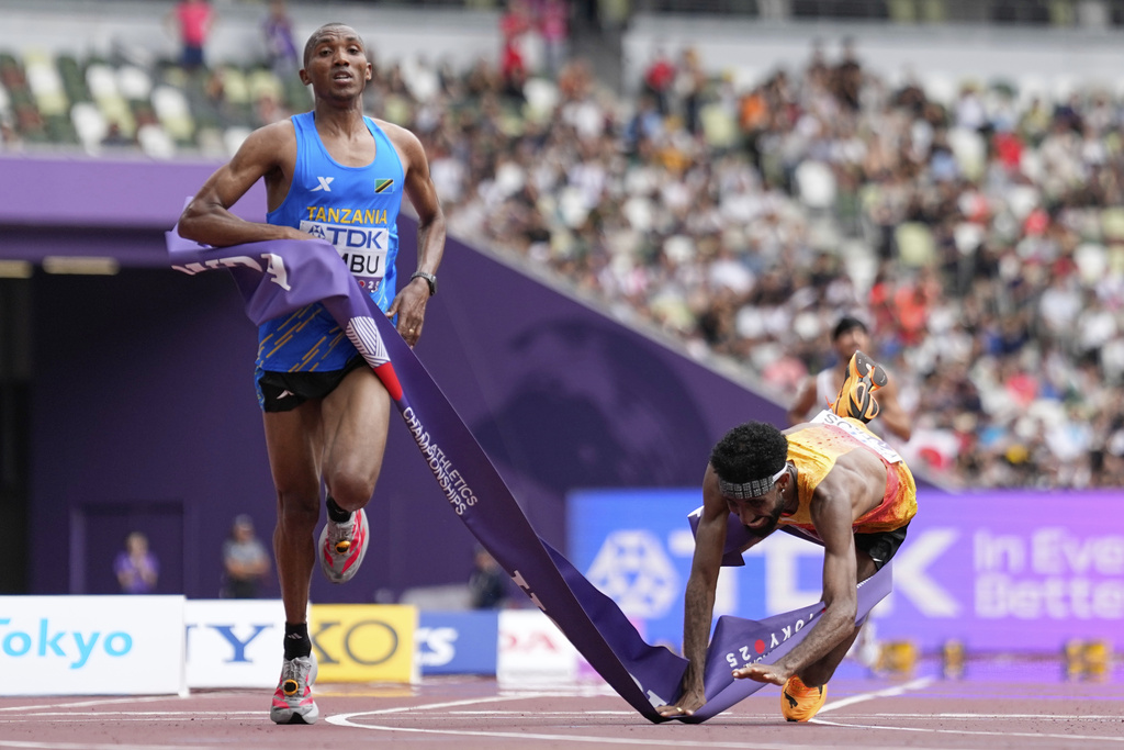 Tanzania's Alphonce Felix Simbu, left, wins the gold in the men's marathon ahead of Germany's Amanal Petros at the World Athletics Championships in Tokyo, Monday, Sept. 15, 2025. (AP Photo/Petr David Josek)