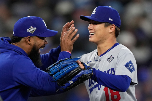 Los Angeles Dodgers pitcher Yoshinobu Yamamoto celebrates with right fielder Teoscar Hernández after throwing compete game against the Toronto Blue Jays in Game 2 of baseball's World Series, Saturday, Oct. 25, 2025, in Toronto. (AP Photo/Brynn Anderson) Los Angeles Dodgers pitcher Yoshinobu Yamamoto celebrates with right fielder Teoscar Hernández after throwing compete game against the Toronto Blue Jays in Game 2 of baseball's World Series, Saturday, Oct. 25, 2025, in Toronto. (AP Photo/Brynn Anderson)