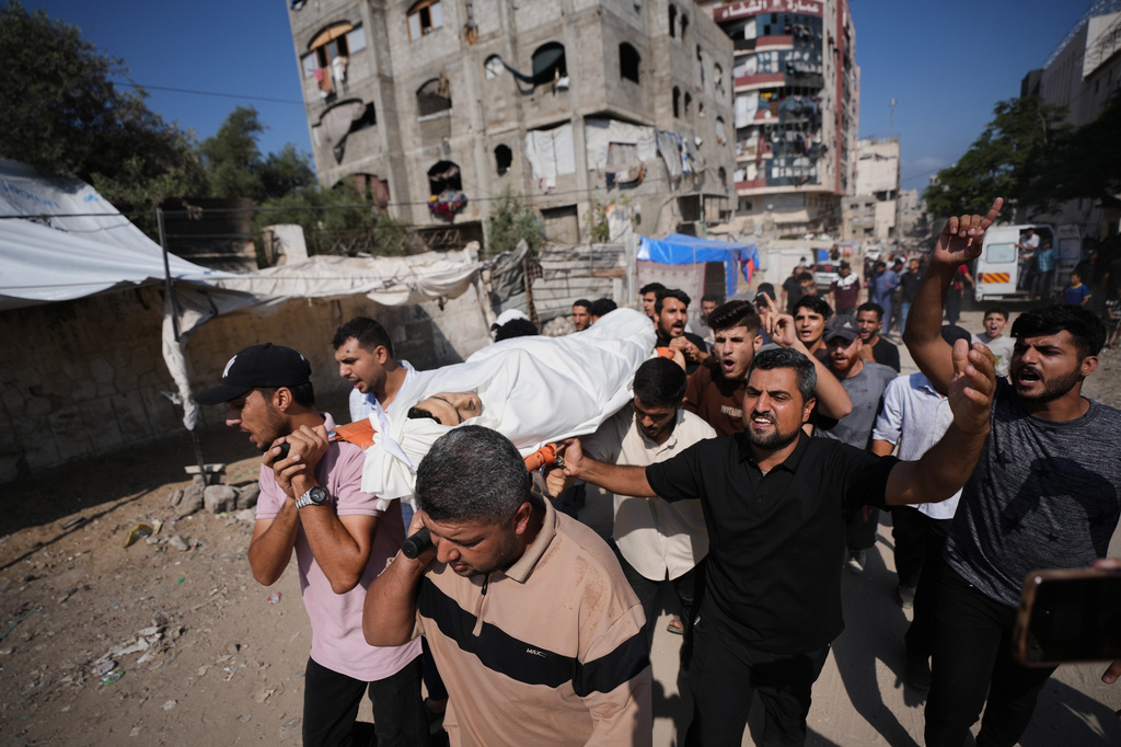 Mourners carry bodies of Palestinians killed in an Israeli army strike during their funeral in Gaza City, Wednesday, Aug. 26, 2026. (AP Photo/Jehad Alshrafi)