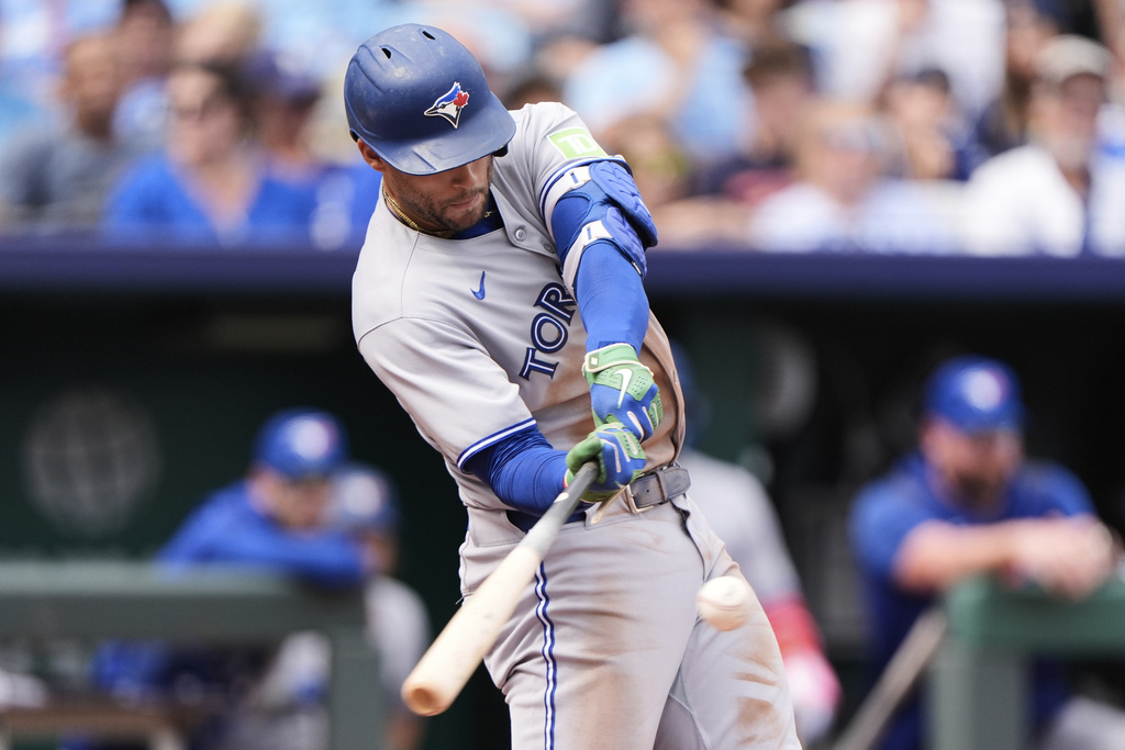 Toronto Blue Jays' George Springer hits an RBI double during the second inning of a baseball game against the Kansas City Royals, Sunday, Sept. 21, 2025, in Kansas City, Mo. (AP Photo/Charlie Riedel)