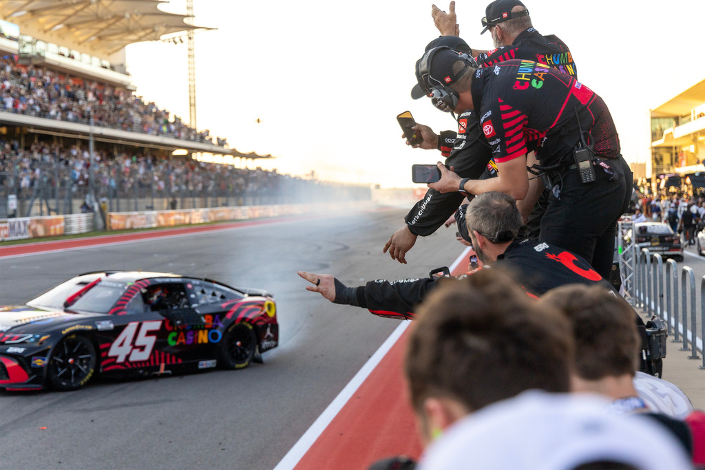 23XI Racing's Tyler Reddick celebrates his win with his team members during a NASCAR Cup Series auto race in Austin, Texas, Sunday, March 1, 2026. (AP Photo/Stephen Spillman)