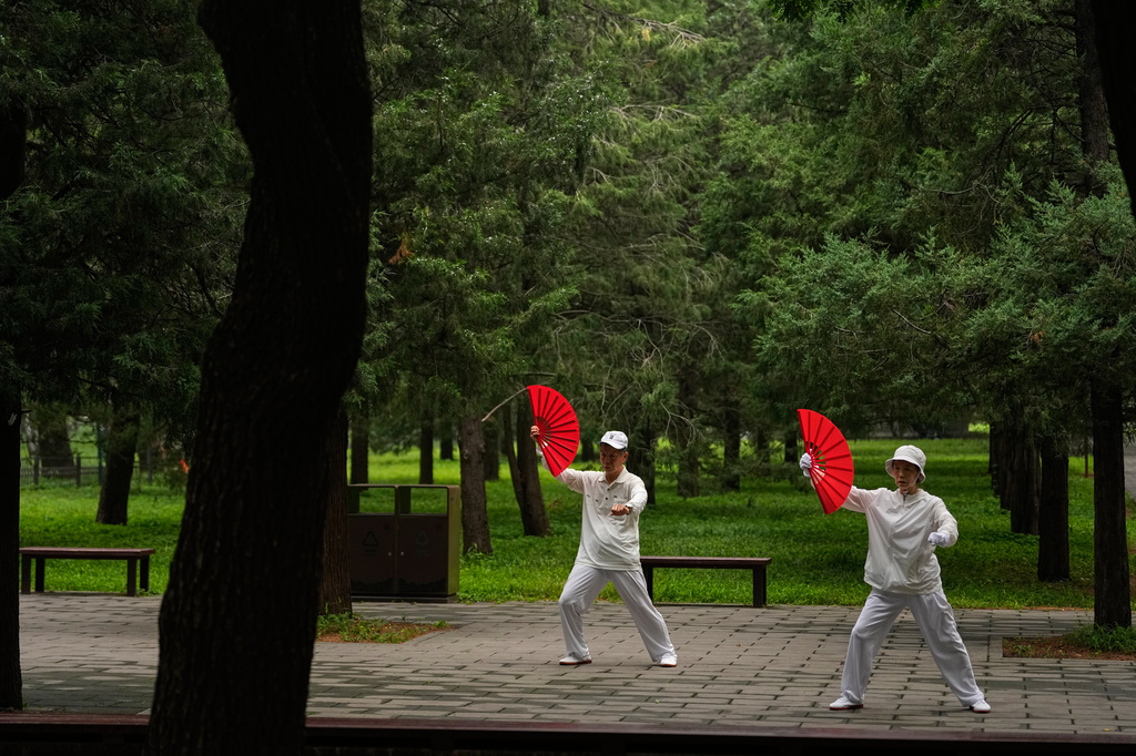 An elderly couple practice Tai Chi at a park near the Temple of Heaven in Beijing, Thursday July 9, 2026. (AP Photo/Andy Wong)