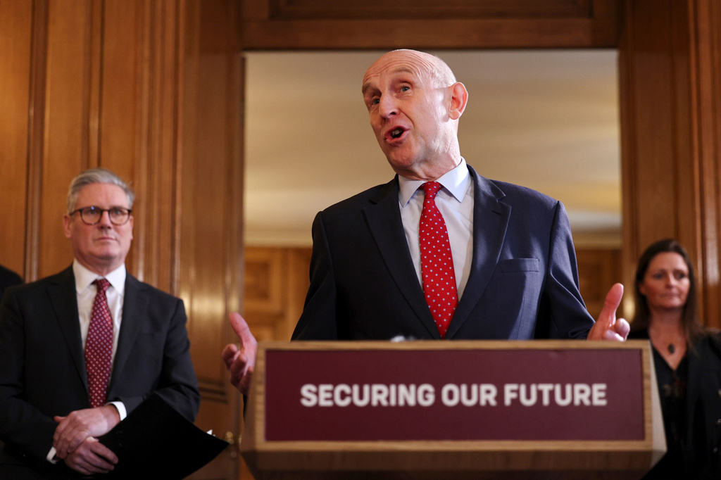 FILE - Britain's Prime Minister Keir Starmer, left, looks on as Defence Secretary John Healey speaks to apprentices and representatives in the defence industry, during a careers fair inside 10 Downing Street in central London, Monday March 3, 2025. (Adrian Dennis/Pool via AP, File)