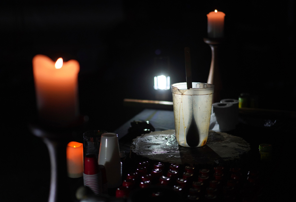 FILE - An empty pitcher and shot sized cups sit on an altar during an ayahuasca ceremony at a retreat in Hildale, Utah, Oct. 14, 2022. (AP Photo/Jessie Wardarski, File)