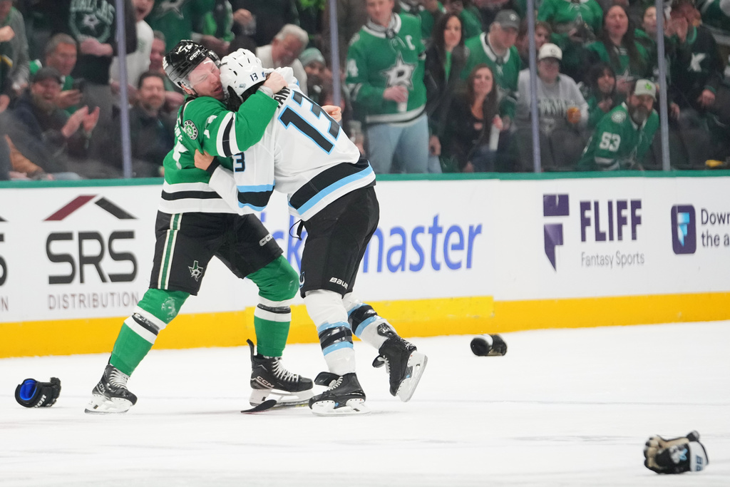 Dallas Stars left wing Adam Erne, left, and Utah Mammoth left wing Brandon Tanev fight during the first period of an NHL hockey game Monday, March 16, 2026, in Dallas. (AP Photo/Julio Cortez)