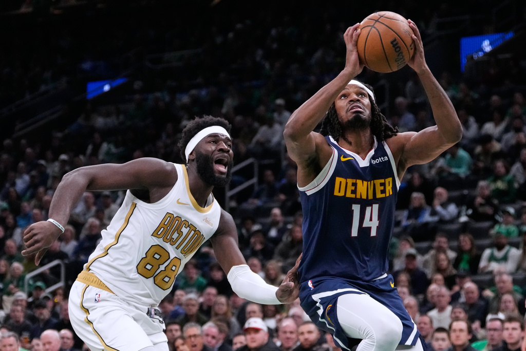 Denver Nuggets forward Daron Holmes II (14) drives to the basket past Boston Celtics center Neemias Queta (88) during the first half of an NBA basketball game, Wednesday, Jan. 7, 2026, in Boston. (AP Photo/Charles Krupa)