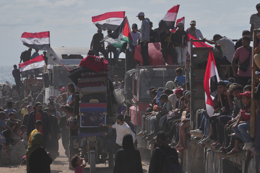 Displaced Palestinians ride on trucks loaded with belongings and wave Egyptian and Palestinian flags as they travel along the coastal road near Wadi Gaza in the central Gaza Strip, moving toward Gaza City, Saturday, Oct. 11, 2025, after Israel and Hamas agreed to a pause in their war and the release of the remaining hostages. (AP Photo/Jehad Alshrafi) Displaced Palestinians ride on trucks loaded with belongings and wave Egyptian and Palestinian flags as they travel along the coastal road near Wadi Gaza in the central Gaza Strip, moving toward Gaza City, Saturday, Oct. 11, 2025, after Israel and Hamas agreed to a pause in their war and the release of the remaining hostages. (AP Photo/Jehad Alshrafi)