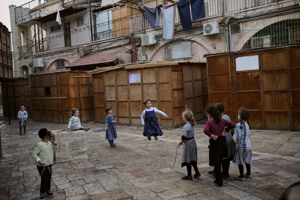 Ultra-Orthodox Jewish children play next to Sukkahs, a temporary structures built for the upcoming Jewish holiday of Sukkot in the Orthodox Jewish neighborhood of Mea Shearim in Jerusalem, Sunday, Oct. 5, 2025. (AP Photo/Ohad Zwigenberg)