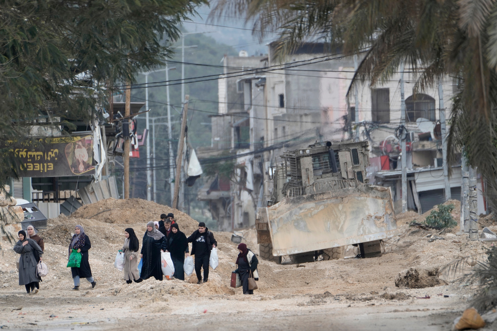 FILE -Residents of the West Bank refugee camp of Nur Shams, near Tulkarem, evacuate their homes as the Israeli military continues its operation in the area on Feb. 11, 2025. (AP Photo/Majdi Mohammed, File)
