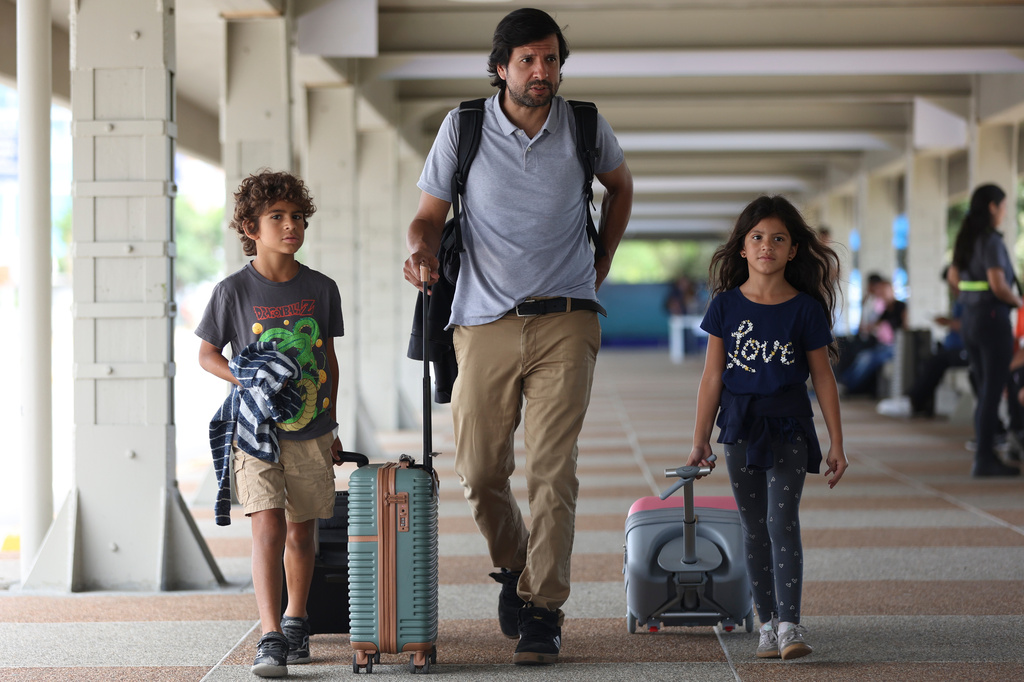Passengers arrive for check in at Simon Bolivar International Airport as it reopens to commercial flights two months after closing due to the earthquake in Maiquetia, Venezuela, Tuesday, Sept. 1, 2026. (AP Photo/Pedro Mattey)