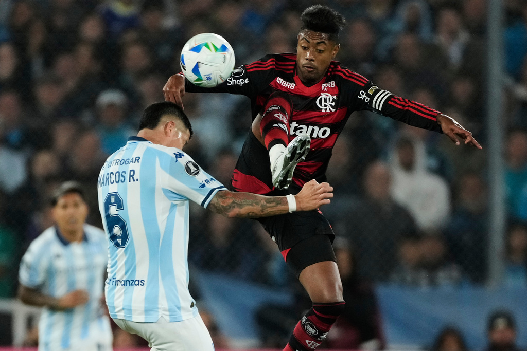 Bruno Henrique of Brazil's Flamengo, right, and Marcos Rojo of Argentina's Racing Club fight for the ball during a Copa Libertadores semifinal second leg soccer match in Buenos Aires, Argentina, Wednesday, Oct. 29, 2025. (AP Photo/Gustavo Garello)