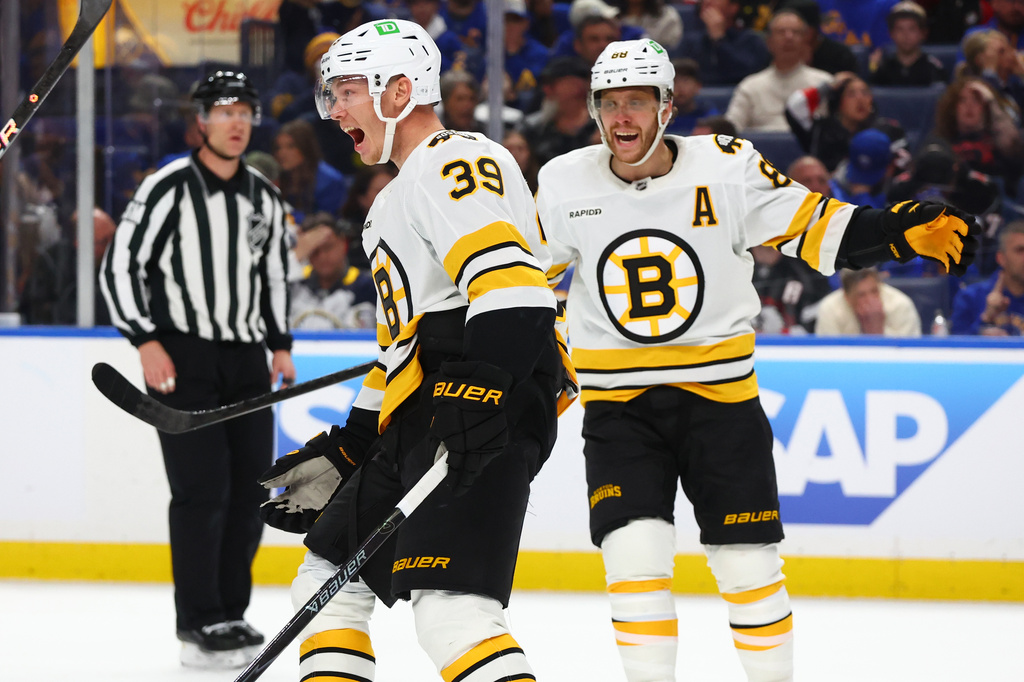 Boston Bruins center Morgan Geekie (39) celebrates his goal with right wing David Pastrnak (88) during the second period in Game 2 of a first-round NHL hockey Stanley Cup playoff series against the Buffalo Sabres Tuesday, April 21, 2026, in Buffalo, N.Y. (AP Photo/Jeffrey T. Barnes)