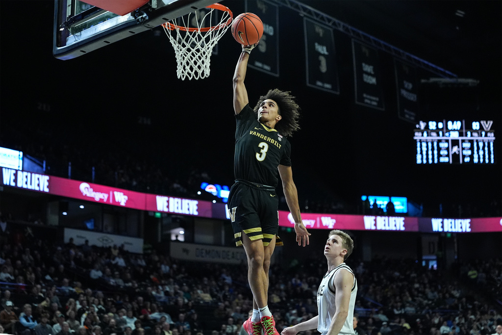 Vanderbilt guard Tyler Tanner (3) drives past Wake Forest guard Isaac Carr for a slam dunk during the second half of an NCAA college basketball game, Sunday, Dec. 21, 2025, in Winston-Salem, N.C. (AP Photo/Matt Kelley)