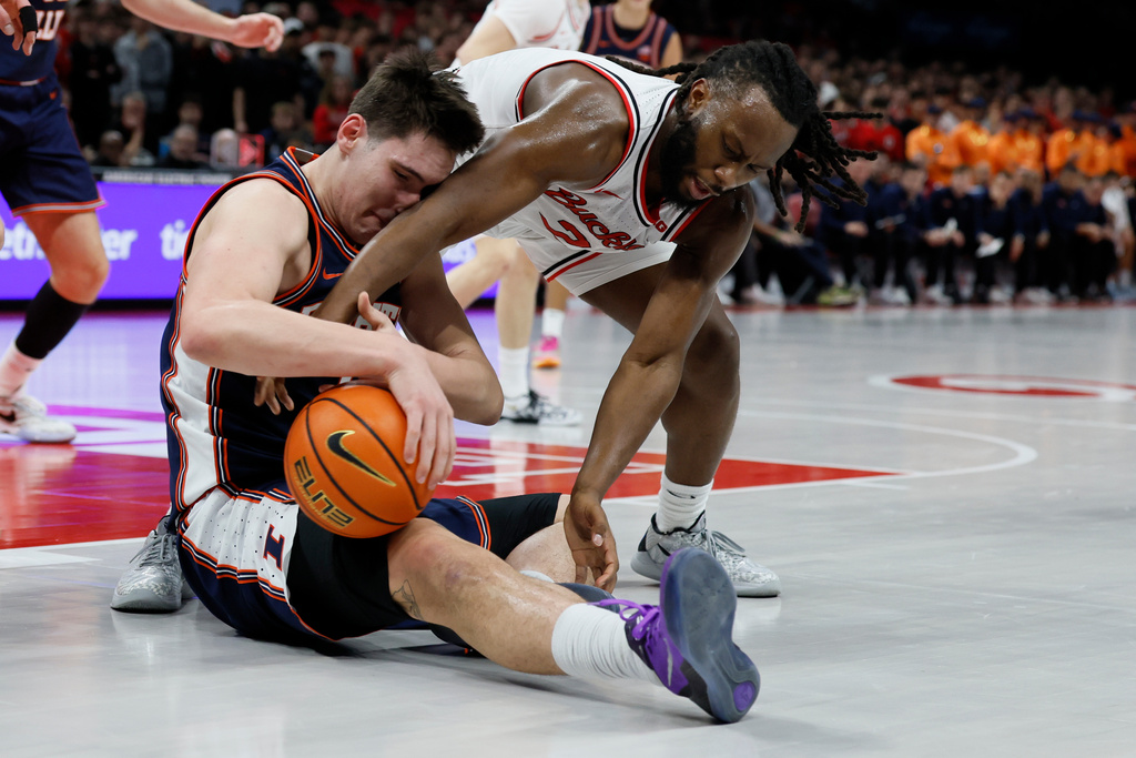Ohio State's Bruce Thornton, right, and Illinois' David Mirkovic fight for the ball during the first half of an NCAA college basketball game, Tuesday, Dec. 9, 2025, in Columbus, Ohio. (AP Photo/Jay LaPrete)