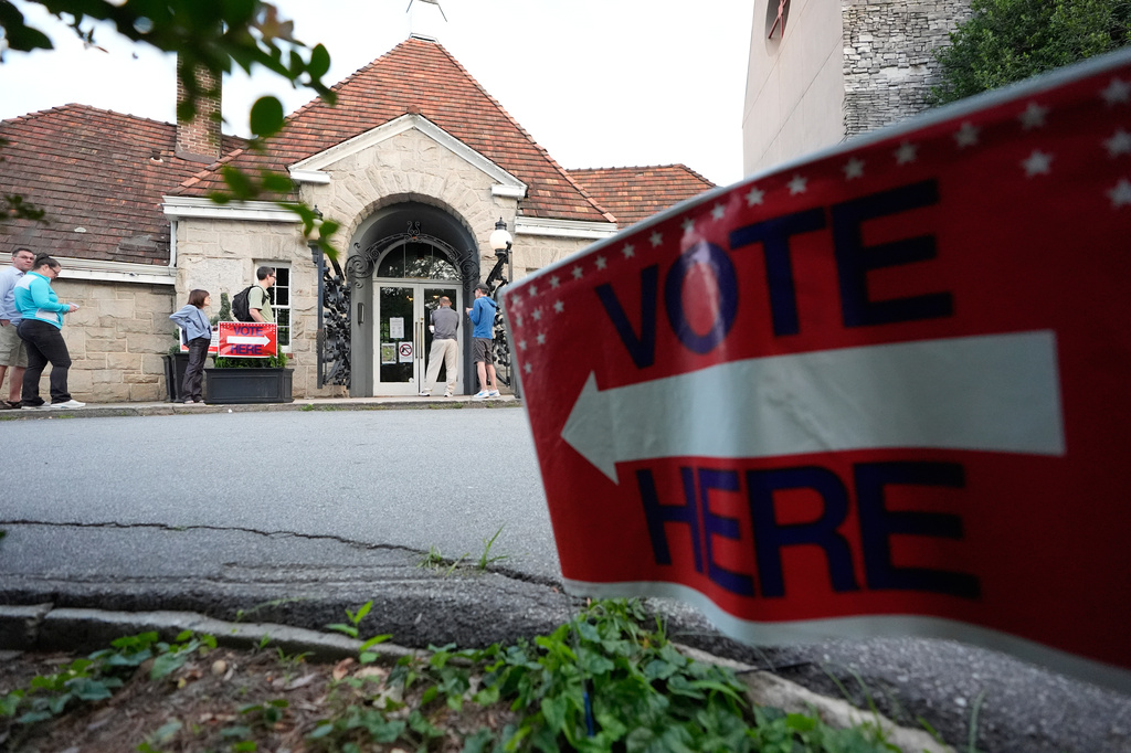 People wait in a line at a precinct before voting on Tuesday, May 19, 2026, in Atlanta. (AP Photo/Brynn Anderson)