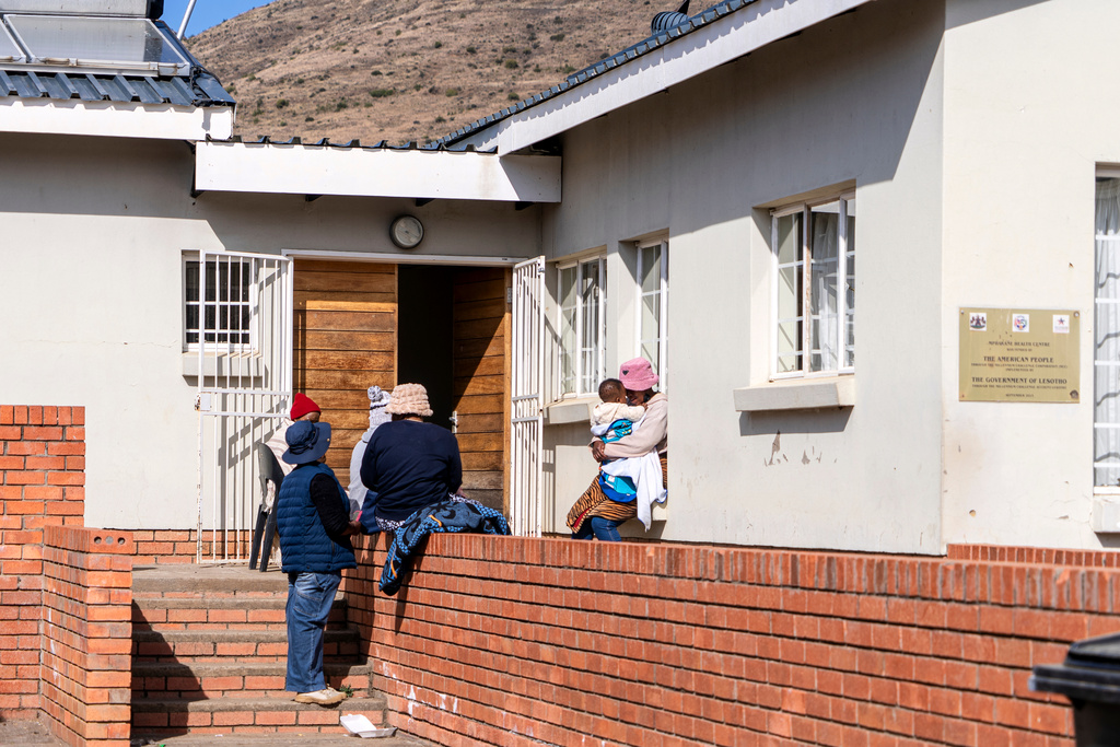 Patients wait outside Mpharane Health Centre in Mohale's Hoek district, Lesotho, Friday, July 10, 2026. (AP Photo/Kayleen Morgan)