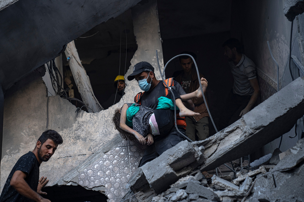 People evacuate the wounded from a building destroyed in an Israeli bombardment in Khan Younis, Gaza Strip, Thursday, Oct. 19, 2023. (AP Photo/Fatima Shbair)