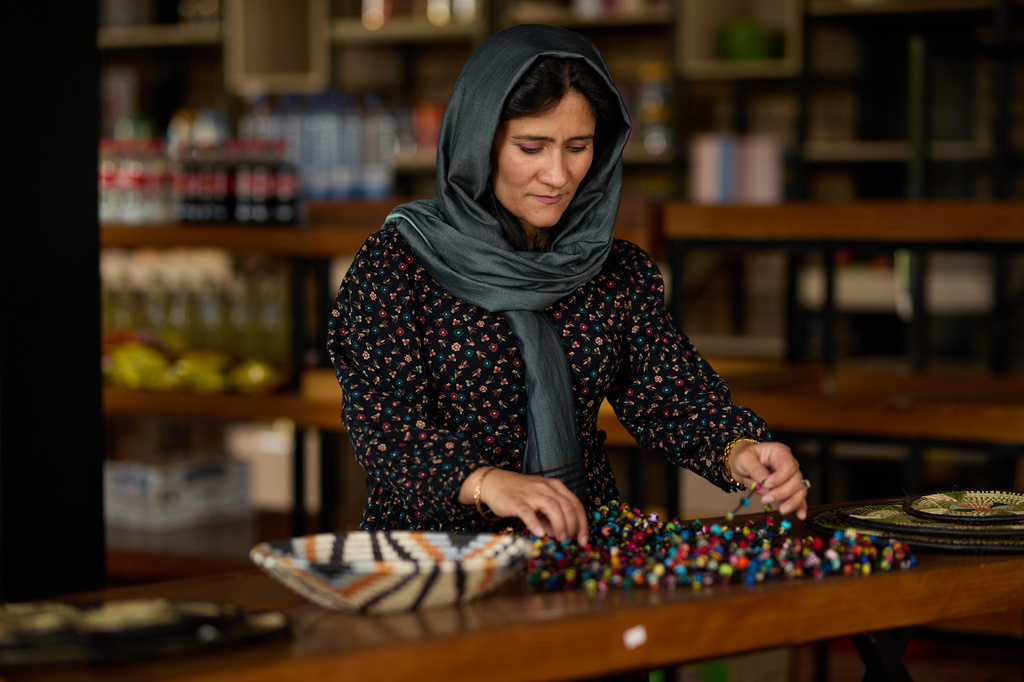 Shabana Basij-Rasikh, co-founder and president of the School of Leadership, Afghanistan (SOLA), arranges beads in Rwanda, Thursday, Aug. 20, 2026. (AP Photo/Yuhi Irakiza)