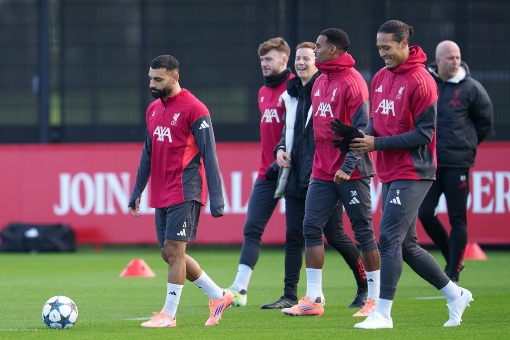 Liverpool's Mohamed Salah, left, takes part in a training session as manager Arne Slot, right, looks on in Liverpool, England, Monday, Dec. 8, 2025. (AP Photo/Jon Super)