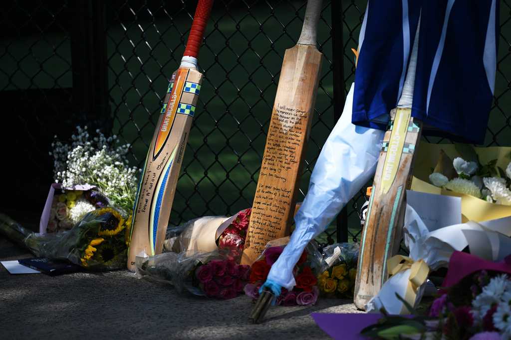 Cricket bats, flowers and notes make an impromptu tribute Thursday, October 30, 2025, for a teenaged cricket player who died in a training accident in Melbourne, Australia. (James Ross/AAP Image via AP)