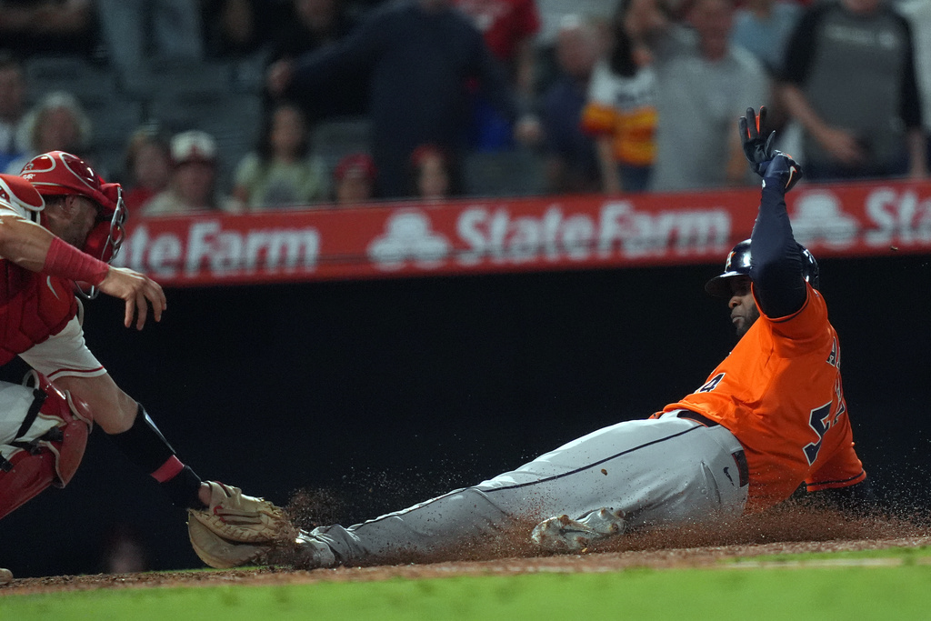 Houston Astros Yordan Alvarez (44) is tagged out by Los Angeles Angels catcher Logan O'Hoppe at home plate during the ninth inning of a baseball game Wednesday, June 10, 2026, in Anaheim, Calif. (AP Photo/Scott Strazzante)