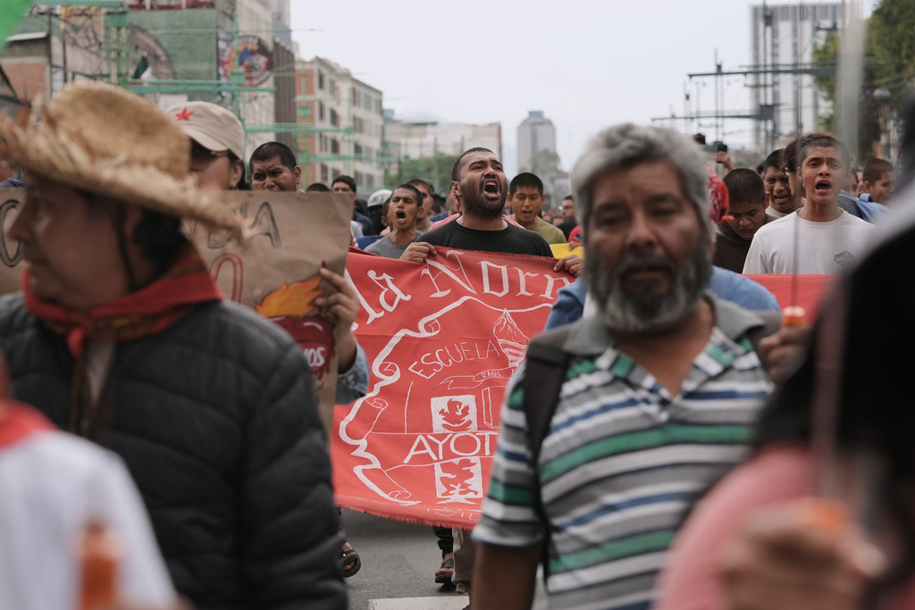 Demonstrators march during a protest commemorating the anniversary of the 1968 Tlatelolco killings, when soldiers fired on student protesters, in Mexico City, Thursday, Oct. 2, 2025. (AP Photo/Claudia Rosel)
