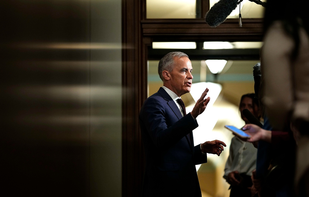 FILE - Prime Minister Mark Carney takes questions from journalists as he arrives on Parliament Hill in Ottawa before a meeting of the federal cabinet, June 2, 2026. (Justin Tang/The Canadian Press via AP, File)