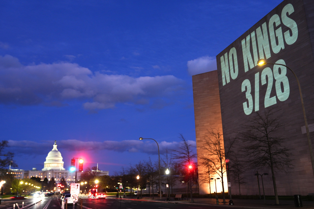 A message promoting an upcoming "No Kings" protest is projected on the National Gallery of Art, with the U.S. Capitol seen in the background, Monday, March 23, 2026, in Washington. (AP Photo/Julia Demaree Nikhinson)