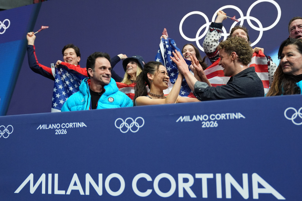 Madison Chock and Evan Bates of the United States react to their scores after competing during the figure skating ice dance team event at the 2026 Winter Olympics, in Milan, Italy, Friday, Feb. 6, 2026. (AP Photo/Stephanie Scarbrough)
