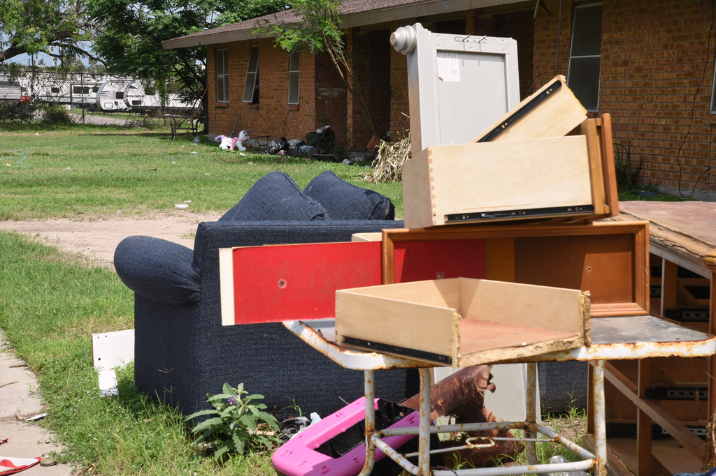 A pile of furniture is piled in a public housing subdivision in Port Isabel, Texas, on April 13, 2026. (AP Photo/Valerie Gonzalez)