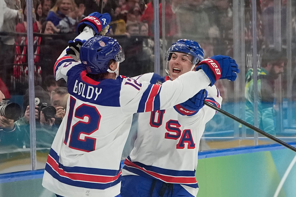 United States' Matt Boldy, left, celebrates after scoring the opening goal during a men's ice hockey gold medal game between Canada and the United States at the 2026 Winter Olympics, in Milan, Italy, Sunday, Feb. 22, 2026. (AP Photo/Hassan Ammar)