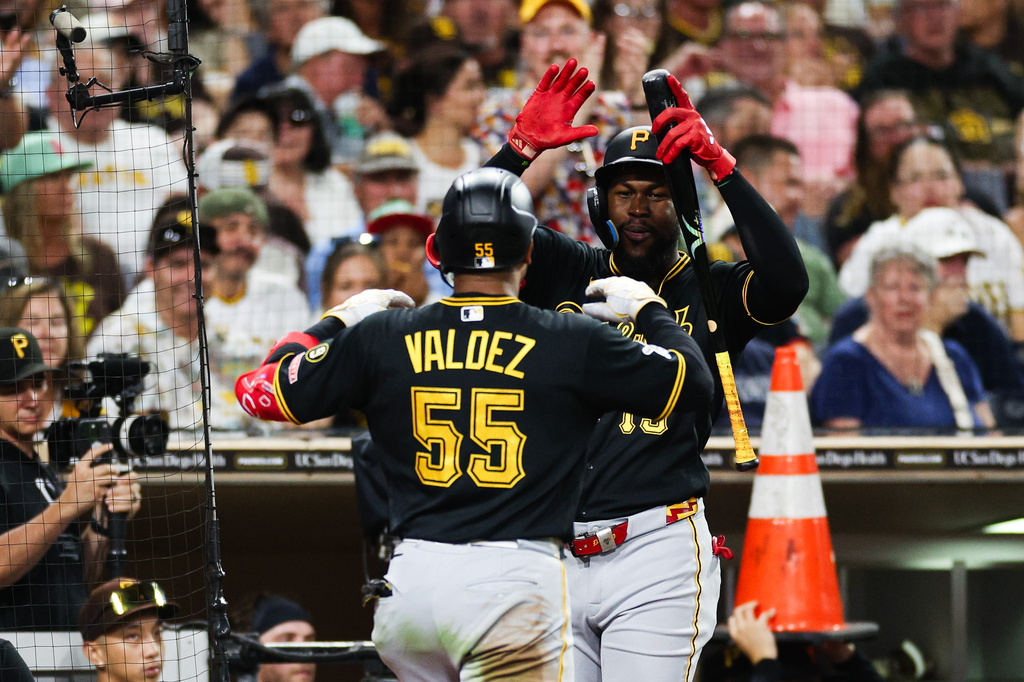 Pittsburgh Pirates' Esmerlyn Valdez (55) is congratulated by Oneil Cruz, center right, after hitting a solo home run against the San Diego Padres in the sixth inning of a baseball game Monday, Aug. 24, 2026, in San Diego. (AP Photo/Derrick Tuskan)