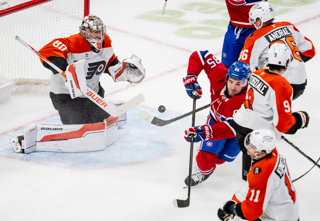 Montréal Canadiens' Alexandre Texier (85) scores on Philadelphia Flyers goaltender Dan Vladar (80) during the first period of an NHL hockey game, in Montreal, Tuesday, Dec. 16, 2025. (Christopher Katsarov/The Canadian Press via AP)