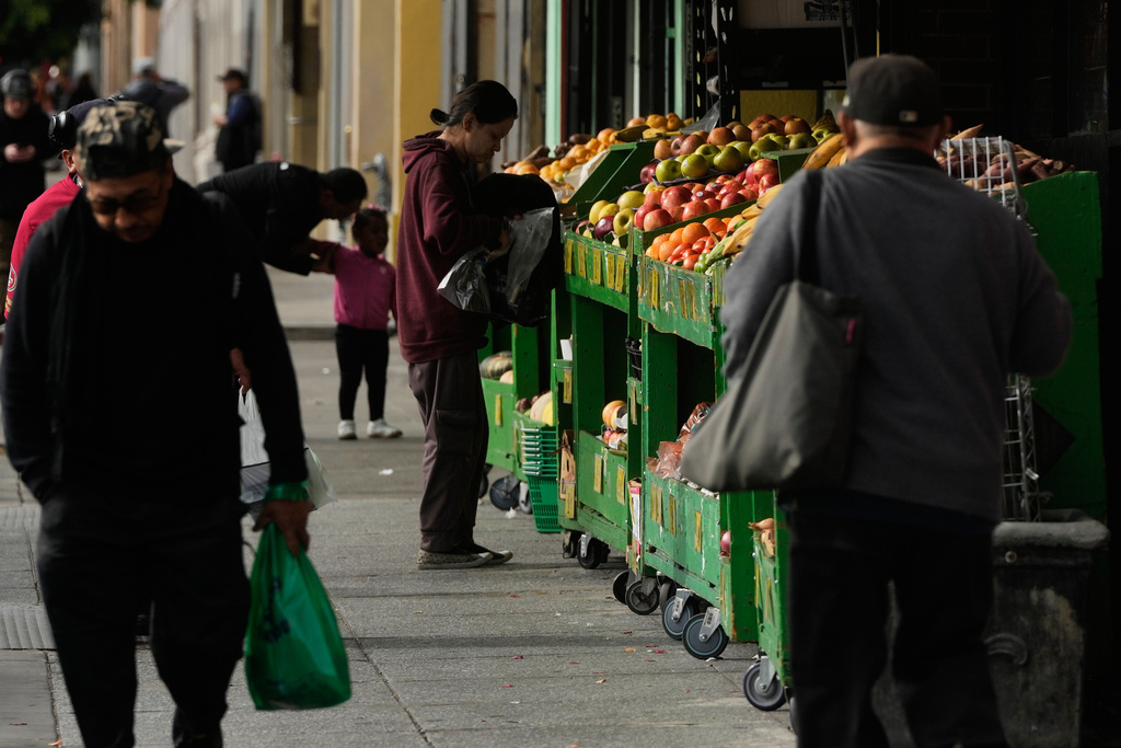 A person shops for produce at a market in San Francisco on Saturday, Nov. 15, 2025. (AP Photo/Jeff Chiu)