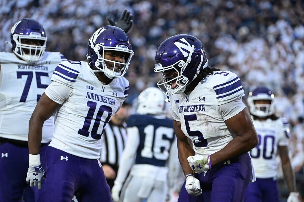 Northwestern running back Caleb Komolafe (5) celebrates after scoring a touchdown during the fourth quarter of an NCAA college football game against Penn State, Saturday, Oct. 11, 2025, in State College, Pa. (AP Photo/Barry Reeger)