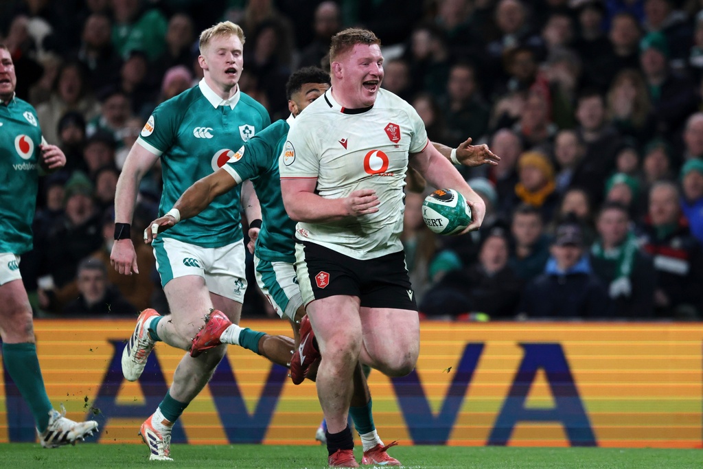 Wales' Rhys Carre, front, breaks through to score his team's first try during a Six Nations rugby union match between Ireland and Wales in Dublin, Ireland, Friday, March 6, 2026. (AP Photo/Peter Morrison)