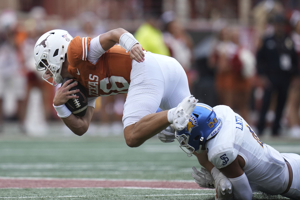 Texas quarterback Arch Manning (16) is stopped by San Jose State linebacker Taniela Latu (4) during the second half of an NCAA college football game in Austin, Texas, Saturday, Sept. 6, 2025. (AP Photo/Eric Gay)