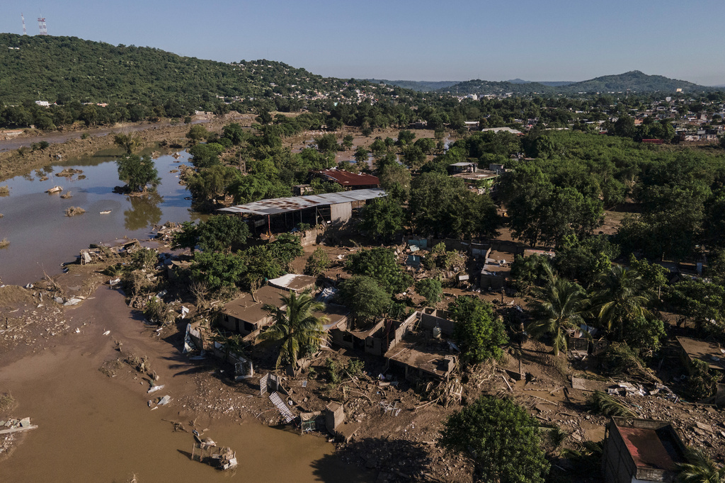 Houses sit damaged after flooding in Poza Rica, Veracruz state, Mexico, Sunday, Oct. 12, 2025. (AP Photo/Felix Marquez)