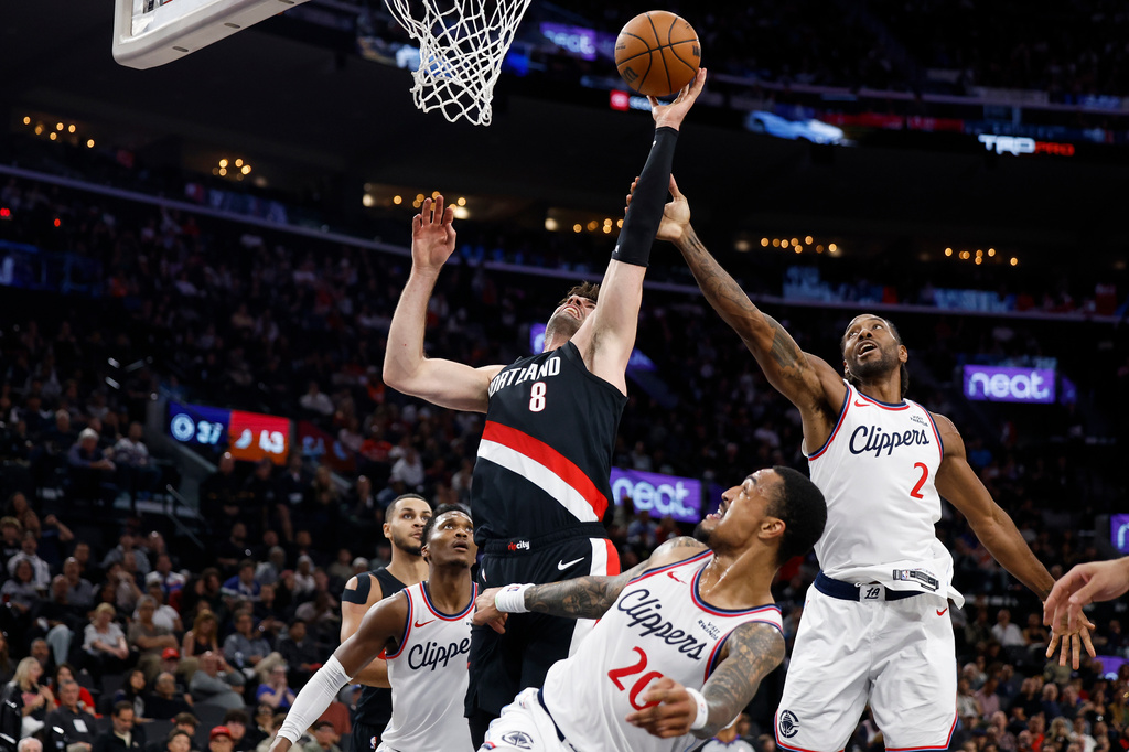 Portland Trail Blazers forward Deni Avdija (8) and LA Clippers forward Kawhi Leonard (2) reach for the ball during the first half of an NBA basketball game Tuesday, March 31, 2026, in Inglewood, Calif. (AP Photo/Caroline Brehman)