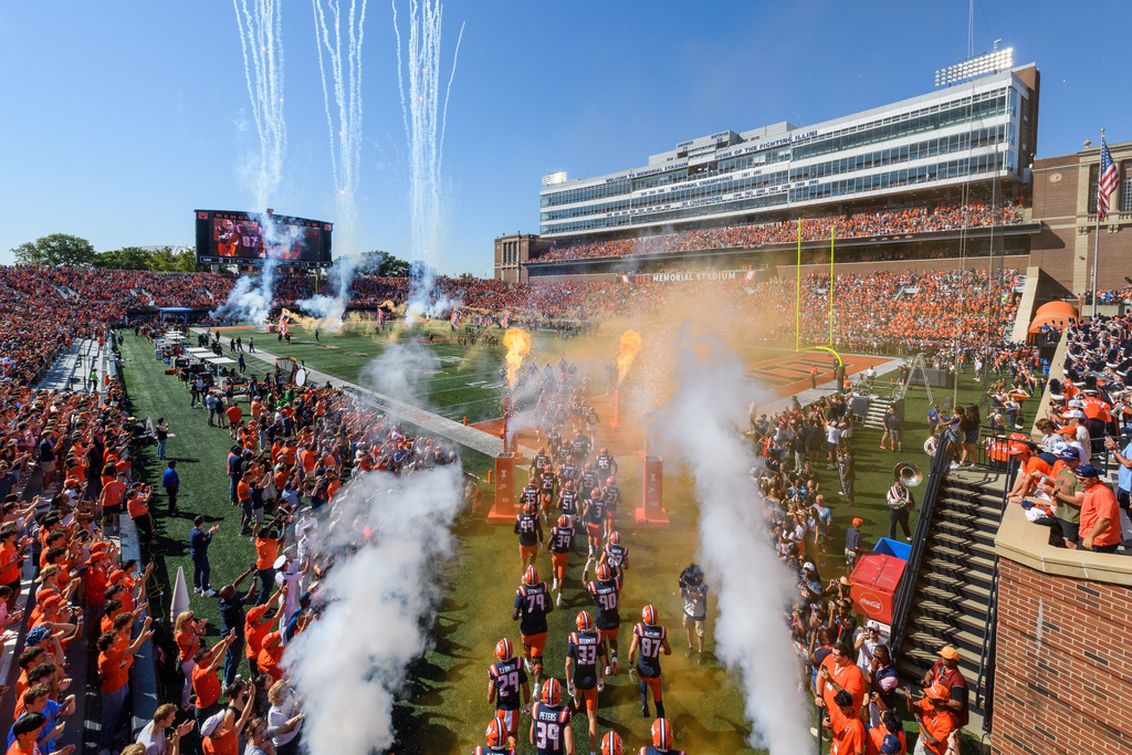Illinois run onto the field before an NCAA college football game between Southern California, Saturday, Sept. 27, 2025, in Champaign, Ill. (AP Photo/Craig Pessman)
