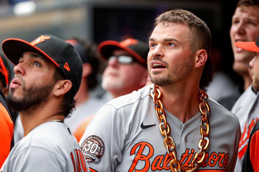 FILE - Baltimore Orioles' Trey Mancini celebrates with a chain around his neck after hitting a solo home run against the Minnesota Twins and watches another go out by Ryan Mountcastle in the sixth inning of a baseball game, July 3, 2022, in Minneapolis. (AP Photo/Bruce Kluckhohn, File)