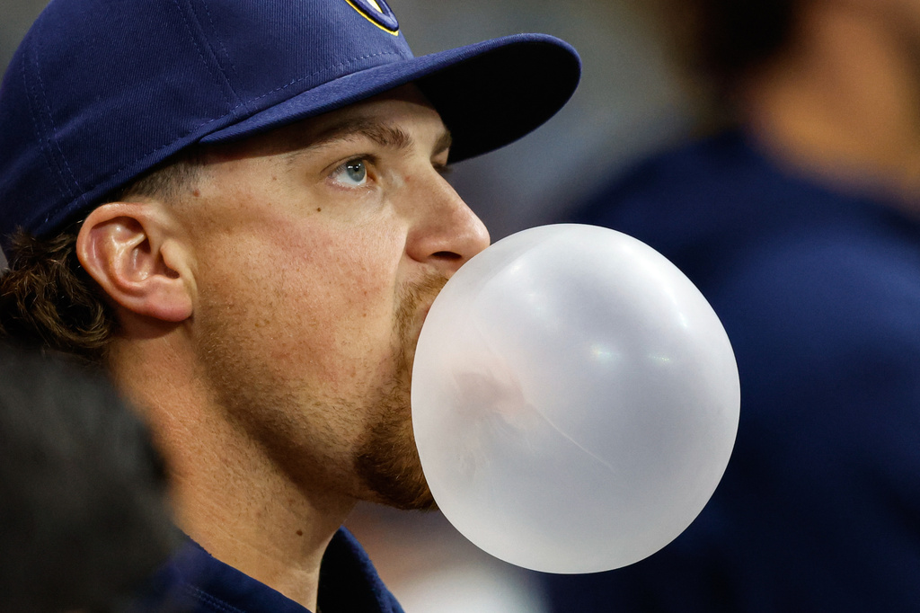 Milwaukee Brewers' Chad Patrick blows a gum bubble in the dugout during the eighth inning of a baseball game against the Pittsburgh Pirates, Saturday, April 25, 2026, in Milwaukee. (AP Photo/Jeffrey Phelps)
