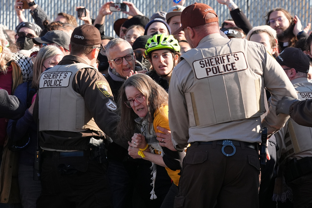 Cook County Sheriff Police guard protesters outside an ICE processing facility in the Chicago suburb of Broadview, Ill., Friday, Nov. 14, 2025. (AP Photo/Nam Y. Huh)
