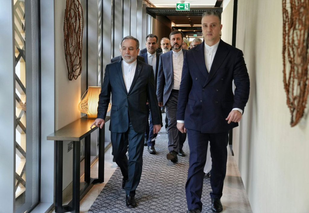 In this photo released by the Iranian Foreign Ministry, Iranian Foreign Minister Abbas Araghchi, left, heads to venue for talks between Iran and the U.S., in Muscat, Oman, Friday, Feb. 6, 2026. (Iranian Foreign Ministry via AP)