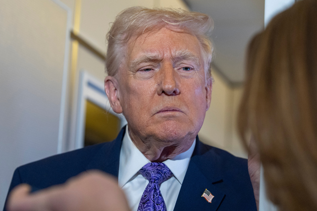 President Donald Trump speaks with reporters while in flight on Air Force One from his Mar-a-Lago estate in Palm Beach, Fla., to Joint Base Andrews, Sunday, Nov. 30, 2025. (AP Photo/Alex Brandon)