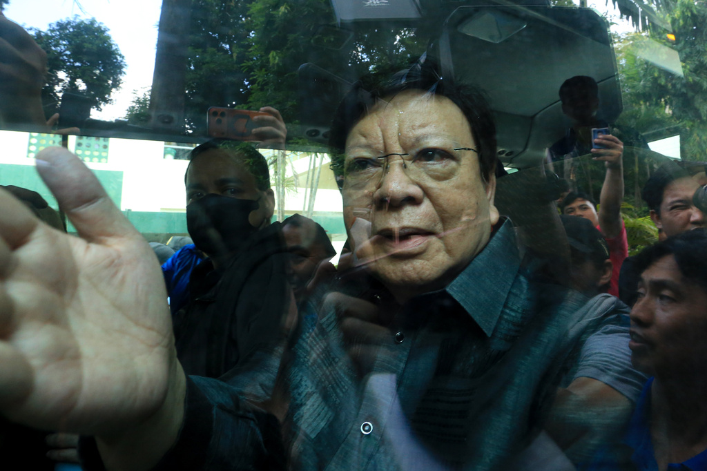 Philippine Sen. Rodante Marcoleta gestures from the window of a police vehicle at the Sandiganbayan special anti-graft court after being arrested for alleged plunder, a non-bailable offense, in Quezon city, Philippines on Monday, July 6, 2026. (AP Photo)