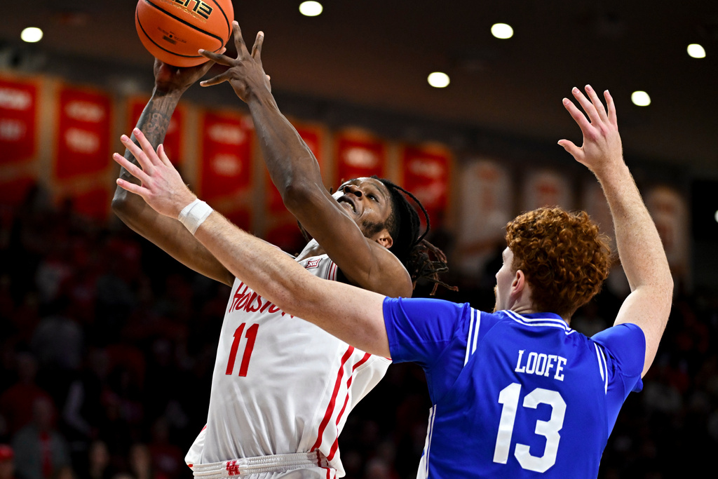 Houston forward Joseph Tugler (11) is fouled by Middle Tennessee State forward Chris Loofe (13) in the first half of an NCAA college basketball game Monday, Dec. 29, 2025, in Houston. (AP Photo/Maria Lysaker)