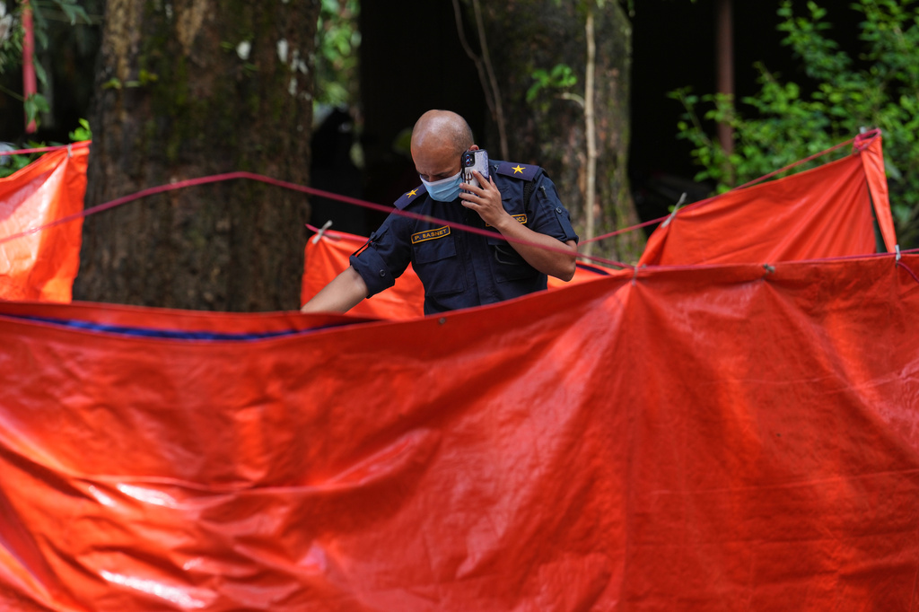 A Nepalese military officer counts bodies recovered in the aftermath of flash floods in Nepal's Nuwakot district, Wednesday, Sept. 2, 2026. (AP Photo/Rajesh Kumar Singh)