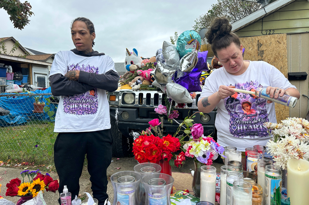 Julius Windham visits a memorial outside the home where authorities say a gunman killed multiple people, including Windham's daughter, in Erie, Pa., on Sunday, Oct. 11, 2026. (AP Photo/Ted Shaffrey)