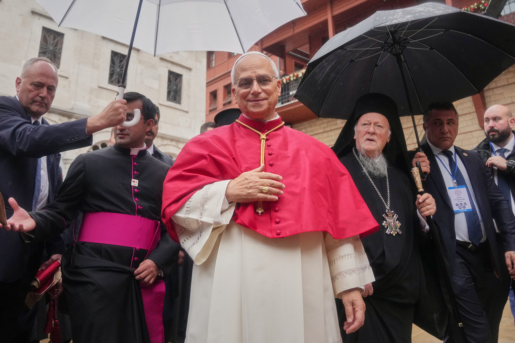 Pope Leo XIV and Ecumenical Patriarch Bartholomew I, the spiritual leader of the world's Eastern Orthodox Christians leave after a doxology service at the Patriarchal Church of Saint George, in Istanbul, Turkey, Saturday, Nov. 29, 2025. (AP Photo/Francisco Seco)